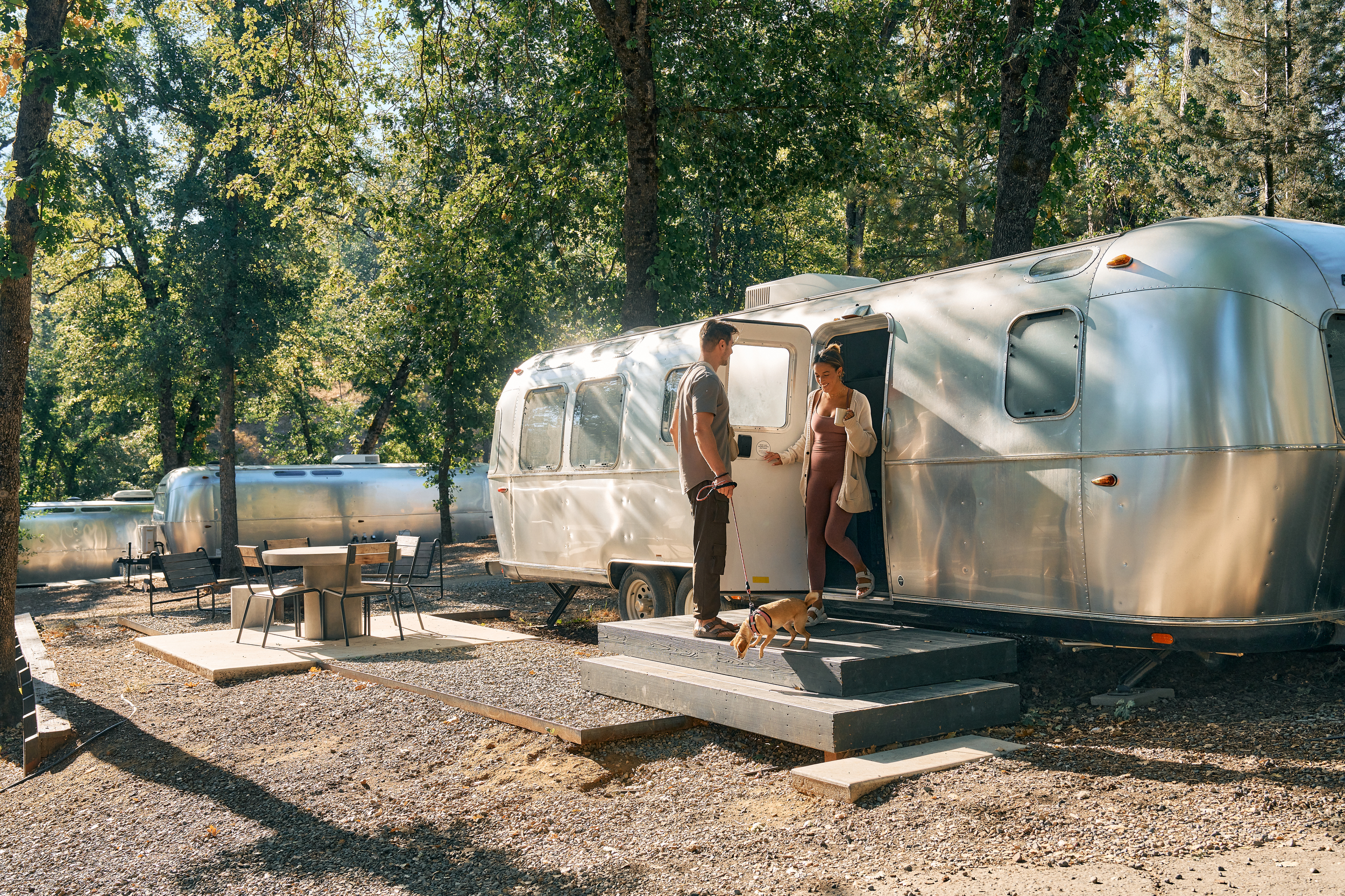 couple and dog in leaving AutoCamp airstream at AutoCamp Yosemite